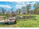 Picturesque pond reflecting the home and trees on a partly cloudy day, dock feature at 3718 S County Road 101 E, Clayton, IN 46118