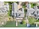 Aerial view of home on the lake with kayaks, dock and large deck overlooking the lake at 3748 Bay Rd S Dr, Indianapolis, IN 46240