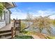 Backyard featuring a multi-level deck with lake views, accessed by wooden steps at 3748 Bay Rd S Dr, Indianapolis, IN 46240