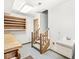 Basement area featuring a utility sink, carpeted stairs and wood cabinetry at 3748 Bay Rd S Dr, Indianapolis, IN 46240