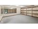 Spacious basement featuring gray carpet, recessed lighting, large mirror and custom shelving with wood trim at 3748 Bay Rd S Dr, Indianapolis, IN 46240