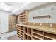 Basement area featuring a pegboard wall, long work bench, utility sink and carpet at 3748 Bay Rd S Dr, Indianapolis, IN 46240