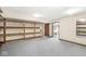 Basement with shelving, door to utility room, and ample space for storage or recreation at 3748 Bay Rd S Dr, Indianapolis, IN 46240