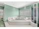 Relaxing bathroom featuring a large soaking tub with jacuzzi jets and a glass-enclosed shower at 3748 Bay Rd S Dr, Indianapolis, IN 46240