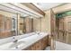 Well-lit bathroom with double vanity sinks, neutral cabinets and an extra-large mirror at 3748 Bay Rd S Dr, Indianapolis, IN 46240