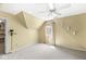 Cozy bedroom with sloped ceilings, a ceiling fan, and a window view at 3748 Bay Rd S Dr, Indianapolis, IN 46240