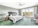 Bedroom boasts a sliding glass door to a private deck and a serene lake view at 3748 Bay Rd S Dr, Indianapolis, IN 46240