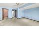 Carpeted bedroom with light blue walls, ceiling fan and two doors with white trim at 3748 Bay Rd S Dr, Indianapolis, IN 46240
