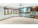 Bright bedroom featuring a beach themed mural, built-in desk, shelving, a ceiling fan and natural light at 3748 Bay Rd S Dr, Indianapolis, IN 46240