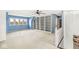 Expansive bonus room with lake views, built in bookcase, and ceiling fan at 3748 Bay Rd S Dr, Indianapolis, IN 46240