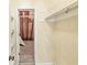 Walk-in closet with rod hanging system, open door to unfinished area at 3748 Bay Rd S Dr, Indianapolis, IN 46240
