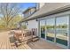 Enjoy outdoor living on this home's deck with a hot tub and beautiful lake views visible through sliding glass doors at 3748 Bay Rd S Dr, Indianapolis, IN 46240