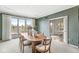 Dining room with an oval table and chairs, neutral carpet, and sliding glass doors to an outdoor patio at 3748 Bay Rd S Dr, Indianapolis, IN 46240