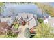 Stunning aerial view of a lakeside home with beautiful landscaping and a gray roof at 3748 Bay Rd S Dr, Indianapolis, IN 46240