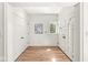 Bright foyer features hardwood floors, large coat closet, window, and an attractive white door at 3748 Bay Rd S Dr, Indianapolis, IN 46240