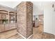 Open living area with a brick column, built-in shelves, and views into the kitchen at 3748 Bay Rd S Dr, Indianapolis, IN 46240