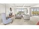 Bright living room with fireplace, beamed ceilings, neutral furnishings, and large windows at 3748 Bay Rd S Dr, Indianapolis, IN 46240