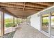 Covered outdoor patio with ample space, offering beautiful views of the lake and surrounding greenery at 3748 Bay Rd S Dr, Indianapolis, IN 46240