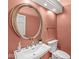 Charming powder room features a pedestal sink, decorative mirror, and designer accents at 3748 Bay Rd S Dr, Indianapolis, IN 46240