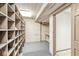 Large storage room featuring custom wood shelving, plank walls and ceiling with recessed lighting at 3748 Bay Rd S Dr, Indianapolis, IN 46240
