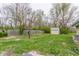 View of backyard featuring green grass, a shed, and a wooden fence at 3959 N Grant Ave, Indianapolis, IN 46226