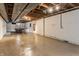 Spacious unfinished basement with concrete floor and exposed ceiling at 3959 N Grant Ave, Indianapolis, IN 46226