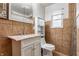 The bathroom features a vanity sink with a marble countertop and tiled walls at 3959 N Grant Ave, Indianapolis, IN 46226