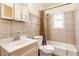 Bathroom with tiled walls, a sink and vanity, and a shower over tub with neutral curtain at 3959 N Grant Ave, Indianapolis, IN 46226