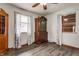 Cozy bedroom featuring hardwood floors, two windows allowing ample natural light, and a vintage cabinet at 3959 N Grant Ave, Indianapolis, IN 46226