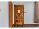 Welcoming entryway featuring a solid wood door with decorative details, wood floors and neutral walls at 3959 N Grant Ave, Indianapolis, IN 46226