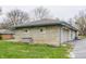 Detached stone garage featuring blue trim, a neutral door, and ample space for parking and storage at 3959 N Grant Ave, Indianapolis, IN 46226