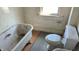 Bathroom featuring a vintage bathtub, toilet, and patterned wallpaper at 437 Jefferson Ave, Indianapolis, IN 46201