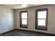 Bedroom with hardwood floors and two windows at 437 Jefferson Ave, Indianapolis, IN 46201