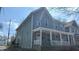 Two-story home with gray siding, white trim, and a covered front porch at 437 Jefferson Ave, Indianapolis, IN 46201