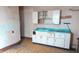Outdated kitchen with worn linoleum flooring and white cabinets with a blue countertop at 437 Jefferson Ave, Indianapolis, IN 46201
