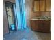 Vintage kitchen with metal cabinets, linoleum floors, and a pass-through to the bathroom at 437 Jefferson Ave, Indianapolis, IN 46201