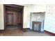Living room features original molding, outdated wallpaper, and non-working fireplace at 437 Jefferson Ave, Indianapolis, IN 46201