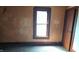 Room features peeling paint and a single window at 437 Jefferson Ave, Indianapolis, IN 46201