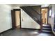 Room features a wooden staircase, peeling paint, and wood flooring at 437 Jefferson Ave, Indianapolis, IN 46201