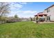 Lush backyard with a red gazebo on a brick patio, offering an ideal setting for outdoor gatherings and relaxation at 4417 Barharbor Ct, Indianapolis, IN 46268