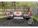 Backyard seating area features a modern wicker seating group with plush cushions, a fire pit, and rock accents at 4417 Barharbor Ct, Indianapolis, IN 46268
