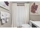 Bright bathroom boasts a shower with white curtain, flower art, and decorative towels at 4417 Barharbor Ct, Indianapolis, IN 46268