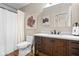 Well-lit bathroom featuring modern vanity with dark wood cabinets, white countertop, and contemporary fixtures at 4417 Barharbor Ct, Indianapolis, IN 46268