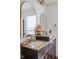 Close-up of bathroom vanity with double mirrors, decorative accents, and neutral countertops at 4417 Barharbor Ct, Indianapolis, IN 46268