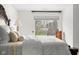 Bright bedroom featuring a neutral color palette, a large window, and soft lighting at 4417 Barharbor Ct, Indianapolis, IN 46268