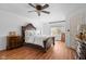 Bright bedroom featuring hardwood floors, large window, and a statement bed frame with matching furniture at 4417 Barharbor Ct, Indianapolis, IN 46268