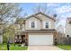 Charming two-story home featuring a two-car garage, brick accents, and mature trees in a well-kept front yard at 4417 Barharbor Ct, Indianapolis, IN 46268