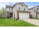 A well-maintained two-story home with a two-car garage, brick accents and a nicely landscaped front yard at 4417 Barharbor Ct, Indianapolis, IN 46268