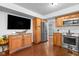 Open kitchen with wood floors, stainless steel appliances, granite countertops and a TV at 4417 Barharbor Ct, Indianapolis, IN 46268