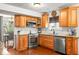 Well-lit kitchen with wood floors, stainless steel appliances, and granite countertops at 4417 Barharbor Ct, Indianapolis, IN 46268